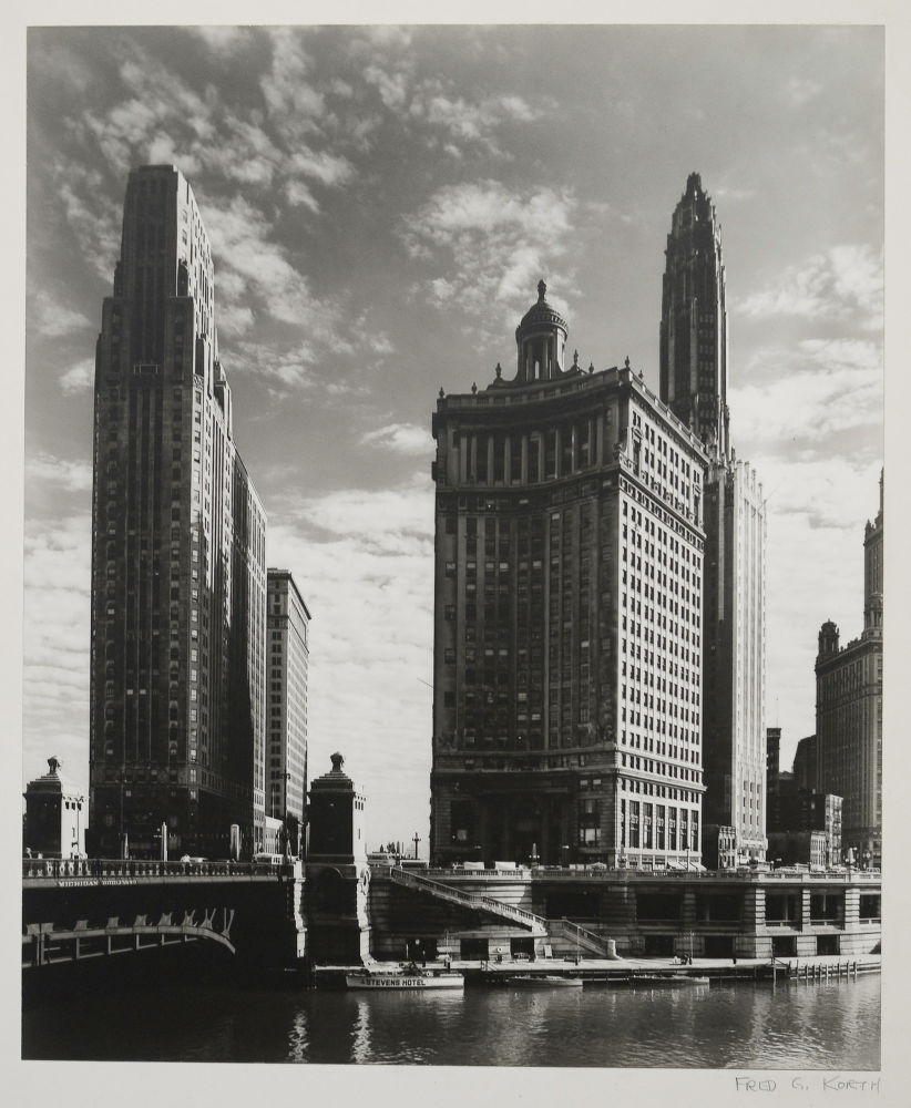 S-0648, Fred G. Korth, Towering buildings look down the Michigan Avenue Bridge at the original site of Fort Dearborn, 1930er